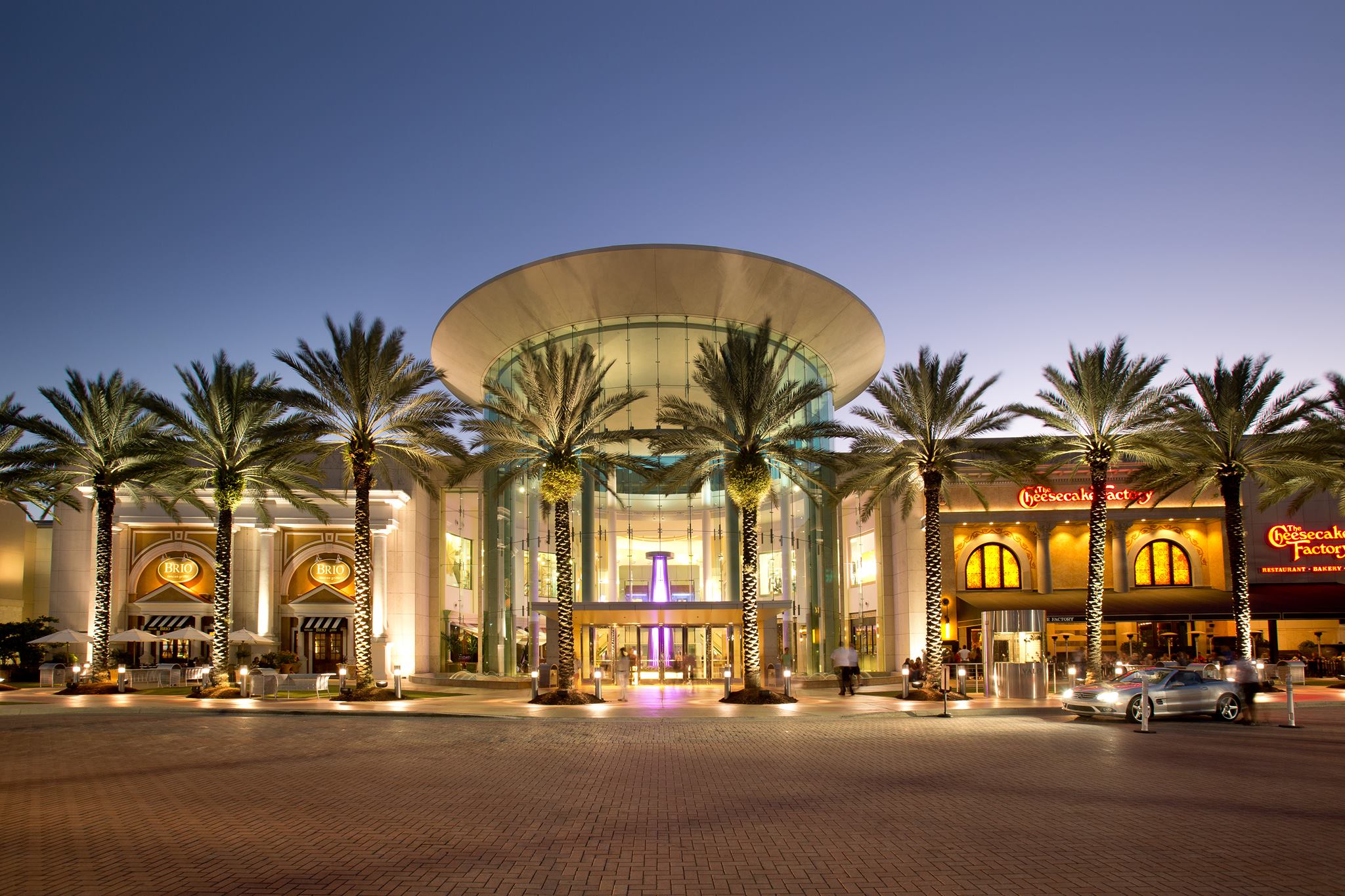 Mid-twilight photo of the entrance of the Mall at Millenia (lit). 